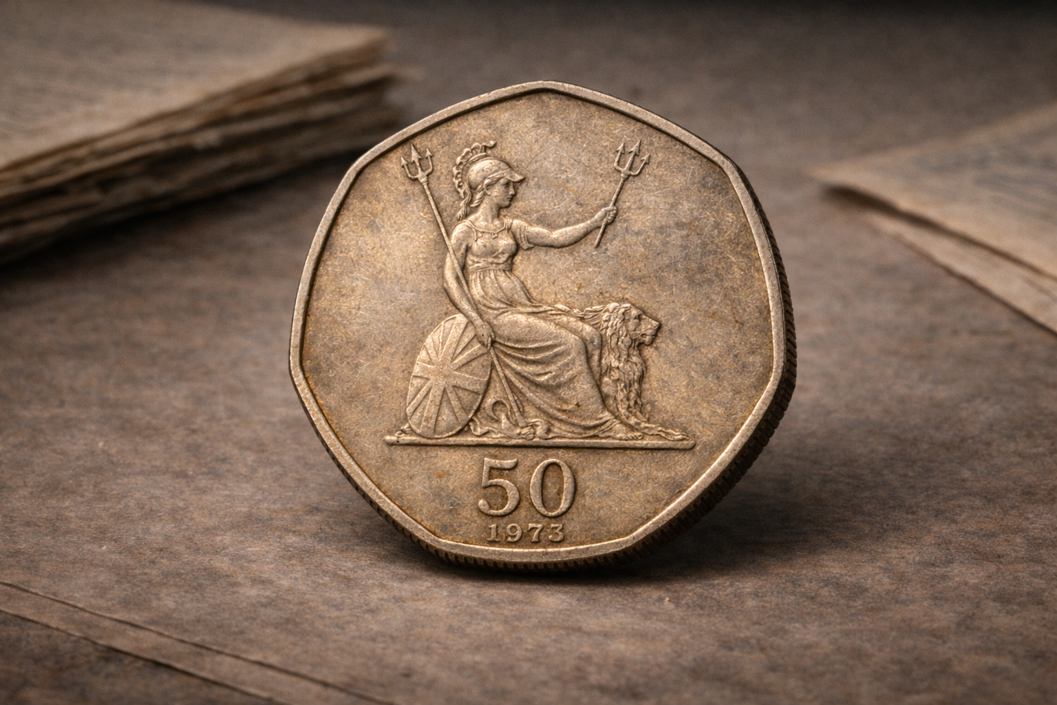 Close view of a 1973 British coin showing early decimal design details and aged metal surface.