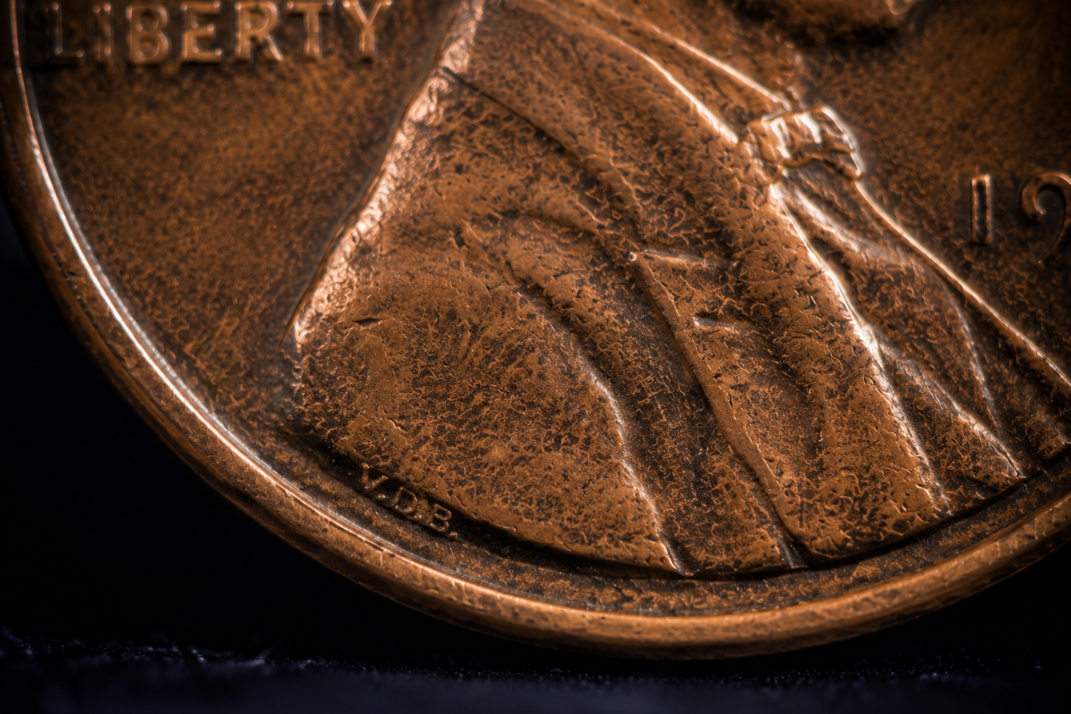 Close-up showing the tiny VDB initials on a Lincoln Wheat Penny.